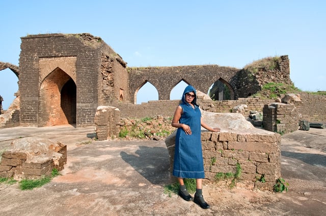 Blue and yellow tile work detail on the red laterite stone walls of Takht Mahal